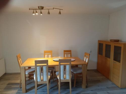 a dining room with a wooden table and chairs at Boardwalk center in Mayrhofen