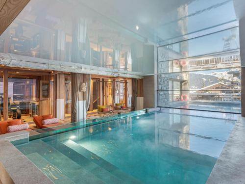 a large swimming pool in a building at Chalet de luxe à Courchevel avec piscine et personnel - FR-1-562-71 in Courchevel