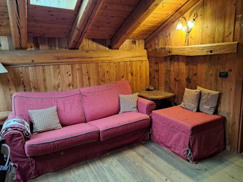 a living room with a couch and a table at L'Abreny in Brusson
