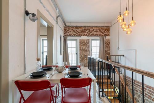 a dining room with a table and red chairs at Historic Izmir Home in Old Town Heart in Konak