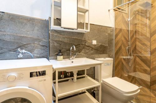 a bathroom with a sink and a washing machine at Historic Izmir Home in Old Town Heart in Konak