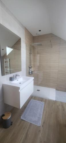 a bathroom with a sink and a bath tub at la petite écurie in Soleymieu