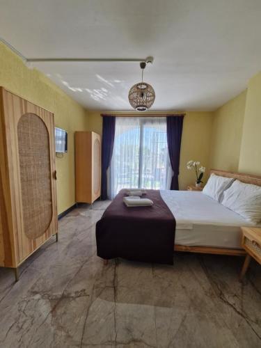 a bedroom with a large bed and a window at Velder House Urla in Urla