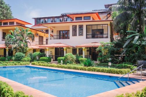 an image of a house with a swimming pool in front of it at Cabatales - 3BHK Villa Near Candolim Beach in Candolim