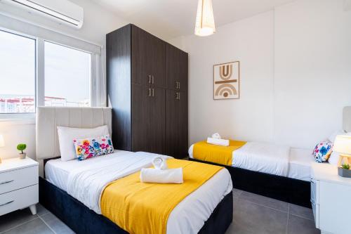 a bedroom with two beds and a window at Sonic 2-Bedroom Apartment in Larnaca