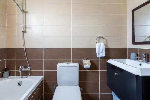 a bathroom with a toilet and a sink at Sonic 2-Bedroom Apartment in Larnaca