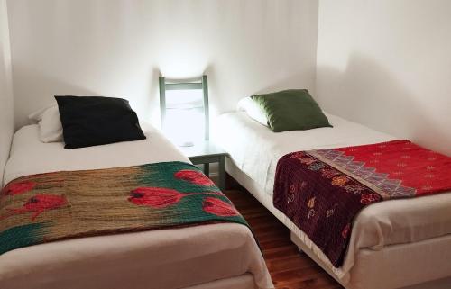 a bedroom with two beds and a table with a blanket at Gite NAYA in Saint-Christophe-sur-Dolaison