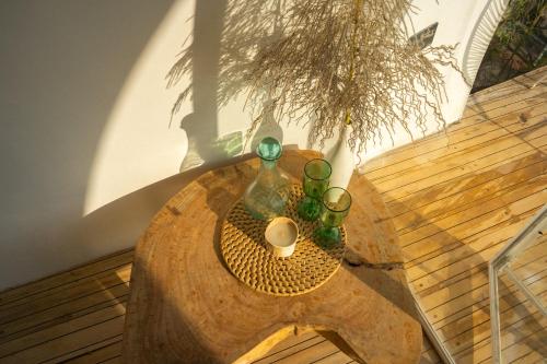 a table with two bottles and a candle on it at Kisoro Art Island in Kisoro