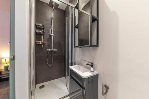 a bathroom with a sink and a shower at 4 bedroom 2 bath beautiful Victorian house in Nottingham
