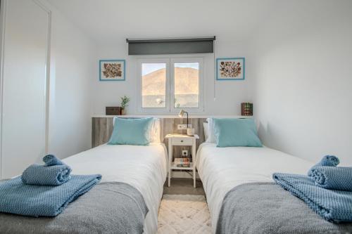 two beds sitting next to each other in a room at Villa Katya by Villalize in Teguise
