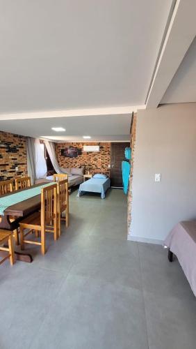 a room with a bed and a table and chairs at Garagem 36 próximo a Serra do Rio do Rastro in Louro Müller