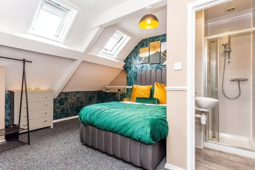 a bedroom with a bed and a shower at Sandhaven House in South Shields