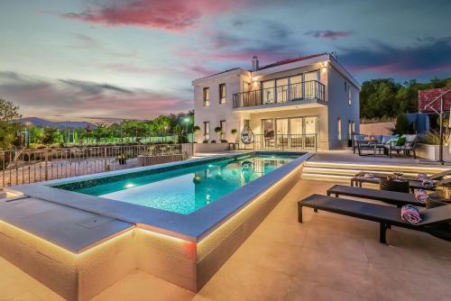 ドゥゴポイエにあるFerienhaus In Dugopolje Mit Privatem Poolの家の前にプールがある家