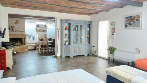 a living room with a blue cabinet and a table at La Buldrina Suite-Home in Castel San Pietro Terme