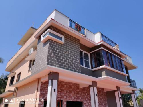 a house with a balcony in front of it at Mystique Copper Smart Villa in Sadāshivgarh