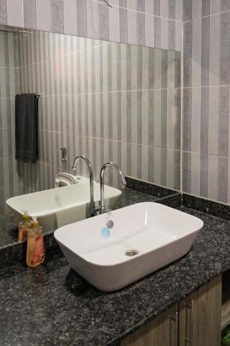 a bathroom with a sink and a mirror at Tsavo Zurani in Voi