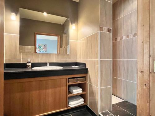 a bathroom with a sink and a mirror at Orchard Cottage in Willingham