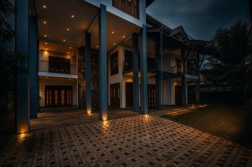 an exterior view of a building at night at Pearl Paradise Villa in Awariwatta