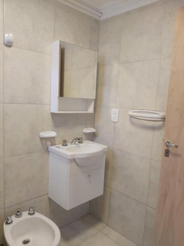 a white bathroom with a sink and a toilet at La Casa de Mirna II in Formosa