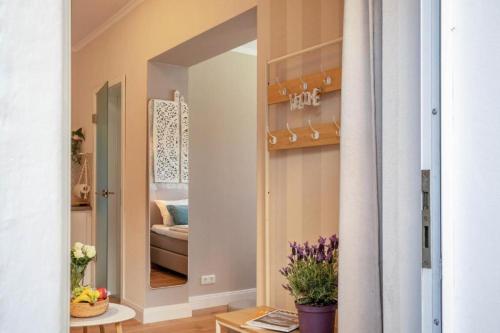 a living room with a mirror and a couch at Villa Gute Zeit - Cosy Apartment in Nortorf