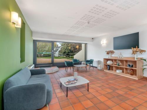 a living room with a couch and a table at B&B HOTEL Alba in Alba