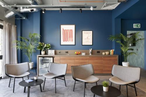 a waiting room with blue walls and chairs at For Students Only Westfield in Edinburgh in Edinburgh