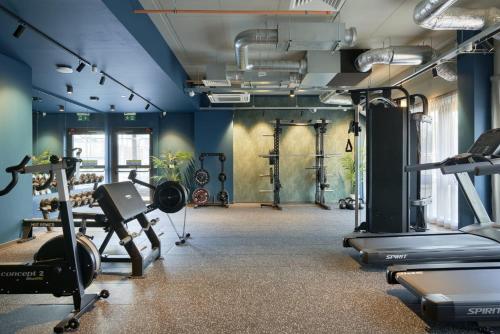 a gym with treadmills and machines in a room at For Students Only Westfield in Edinburgh in Edinburgh