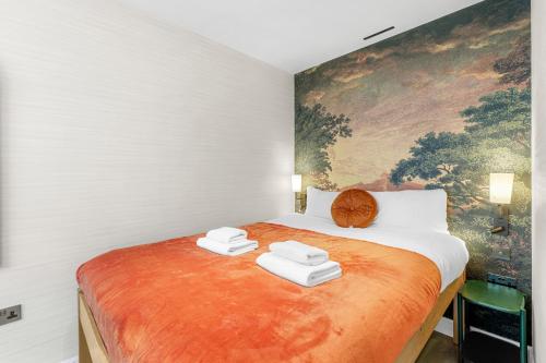 a bedroom with a large bed with towels on it at 1 Bed Flat in London in London