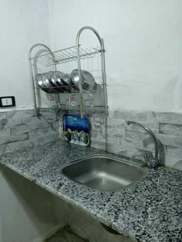 a sink with two faucets on top of a counter at Sun Rise House Luxor in Al Aqālitah