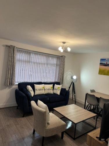 a living room with a couch and a table at Whitford living 1 South Shields in West Boldon