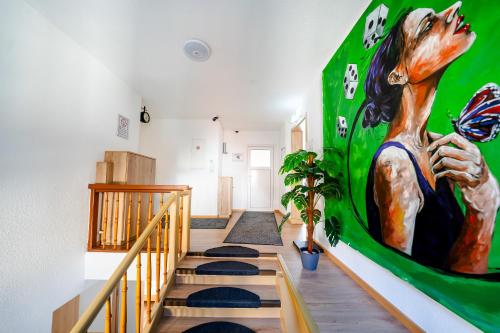 a room with a staircase with a green wall at Hotel Bären in Hechingen