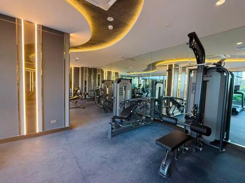 a gym with cardio equipment in a building at New great pool and gym condo chiangmai in Chiang Mai