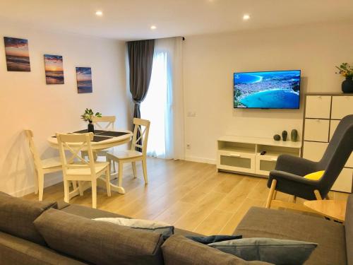 a living room with a couch and a table at 101 - Beachside Renovated 1BR apt w private garden in Cambrils