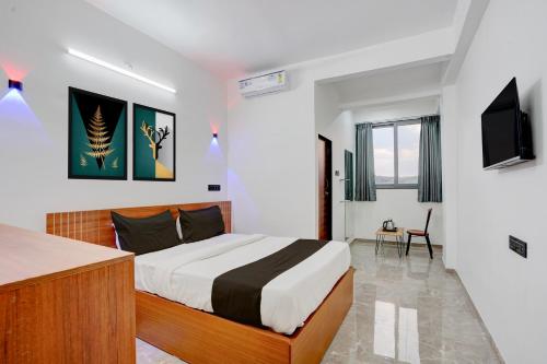 a hotel room with a bed and a television at Collection O Kanifnath Trek Pune in Jadhavwadi