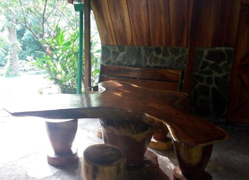 a wooden bench sitting in front of a window at Rancho de Lelo Ecolodge in Monteverde Costa Rica