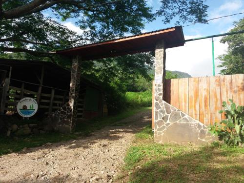 a gate to a barn with a wooden fence at Rancho de Lelo Ecolodge in Monteverde Costa Rica