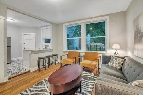 a living room with a couch and a table at Beautiful Brand New Tower Grove Unit 1s in Clifton Heights