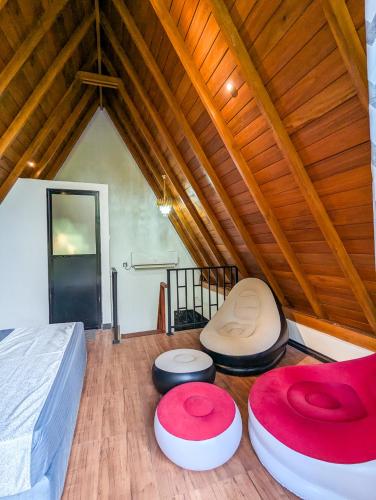 a bedroom with a bed and two circular objects on the floor at Shenu Villa in Talpe