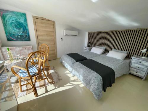 a bedroom with a bed and a table and a chair at Casa Bella Vista in Cómpeta