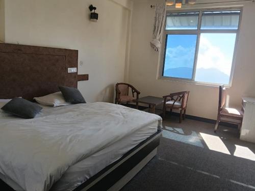 Ένα ή περισσότερα κρεβάτια σε δωμάτιο στο Lekwar Home stay & Restaurant