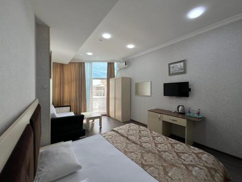 a hotel room with a bed and a desk at Baku Center inn NS in Baku