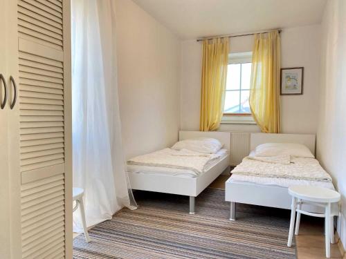 a bedroom with two beds and a window at Orth A3 - Hafentraum in Orth