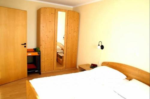 a bedroom with a bed and a wooden closet at Orth C19 in Orth