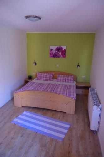 a bedroom with a large wooden bed with a purple blanket at Orth - E37 in Orth