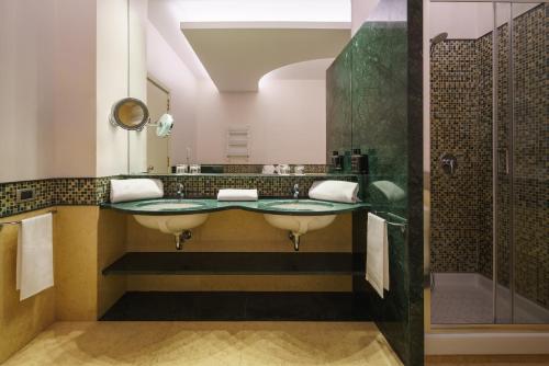 a bathroom with two sinks and a shower at Exe Majestic in Naples