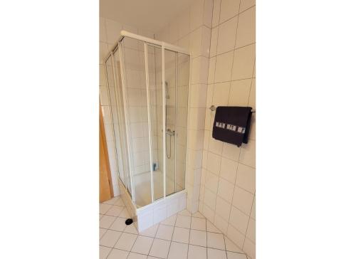 a shower with a glass door in a bathroom at Blue Water in Orth