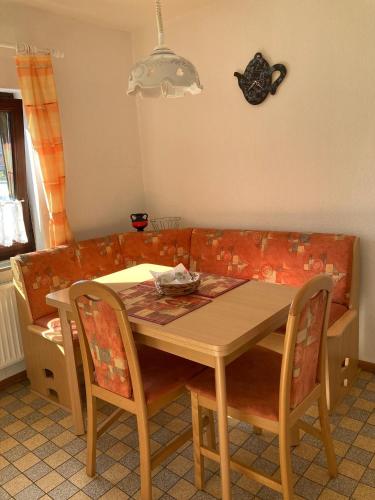 a table and chairs in a living room with a couch at Orth Poststraße 8 EG in Orth