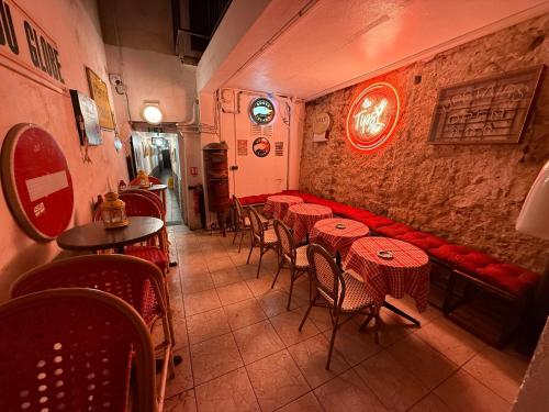 a restaurant with red tables and chairs in a room at LE Globe in Paris