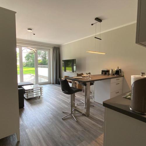 a kitchen and living room with a table and chairs at Columbus in Petersdorf auf Fehmarn