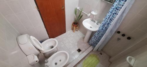 a bathroom with a toilet and a sink at Velero de Mar in Las Grutas